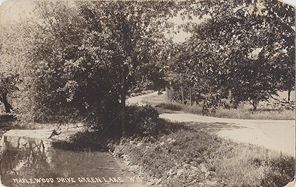 10808-Maplewood Drive Green Lake Wis. A view looking South along Maplewood Drive in the area that would become Hattie Sherwood Park. - Postmarked 1918