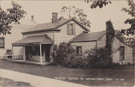 10849-Oldest House in Green Lake, located on Hill Street. The Oldest house in Green Lake lasted until the 1960s when Norman Bierman razed it to build the building that is now the US Post Office.