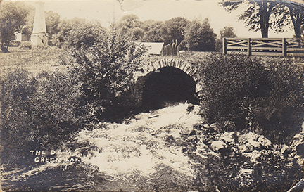 10935-The Dam at the Mill Race. Here is a look further up the original channel of the Puchyan River. You can see the water tower in the top left of the photo.  It provided water for the Jail & Courthouse. -Postmarked 1914