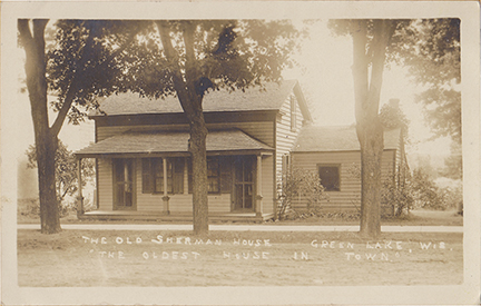 11018-The Old Sherman House, Oldest House in Green Lake, Hill Street. The Oldest House in Green Lake was built by the Olin's across from the court house. Later it became the home of Erna Schlagel until it was demolished by Norman Bierman. I need to find out why it is labeled the Sherman House.