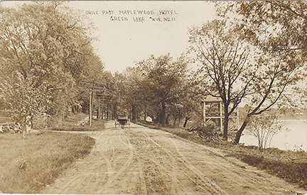 11052-Drive Past Maplewood Hotel, Horse & buggy, Spring House. By 1912 Victor Lawson had started the last bit of road from his estate to the C&NW Depot.  Here we see a horse pulling a buggy past the Techura Spring at the Maplewood Hotel. - Postmarked 1912